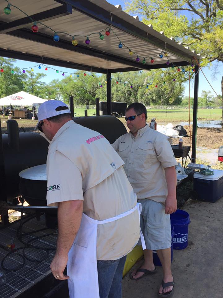 swine and dine team preparing their smoker and grill equipment for the competition