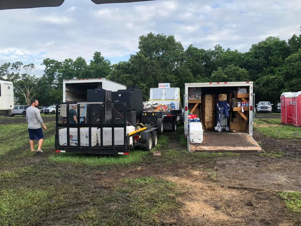 swine and dine trailer and other materials being setup and brought into the festival