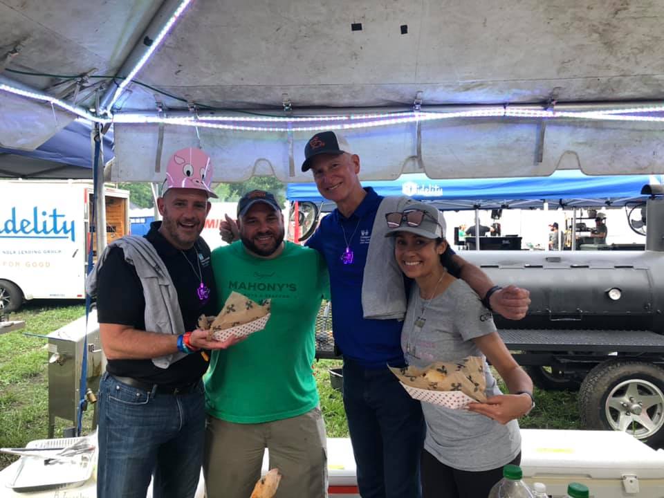 Hogs fest swine and dine group photograph under their tent