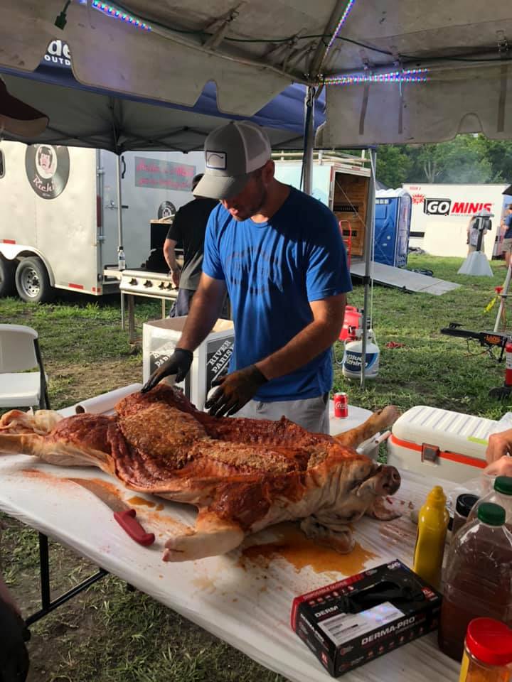 swine and dine team preparing their hog to feed the fest!