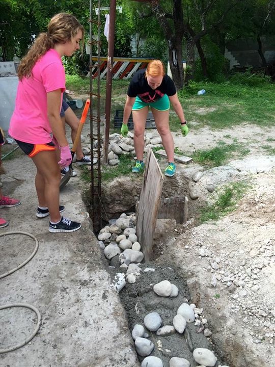 Casa Bethesda volunteers digging a perimeter for concrete bricks for their expansion