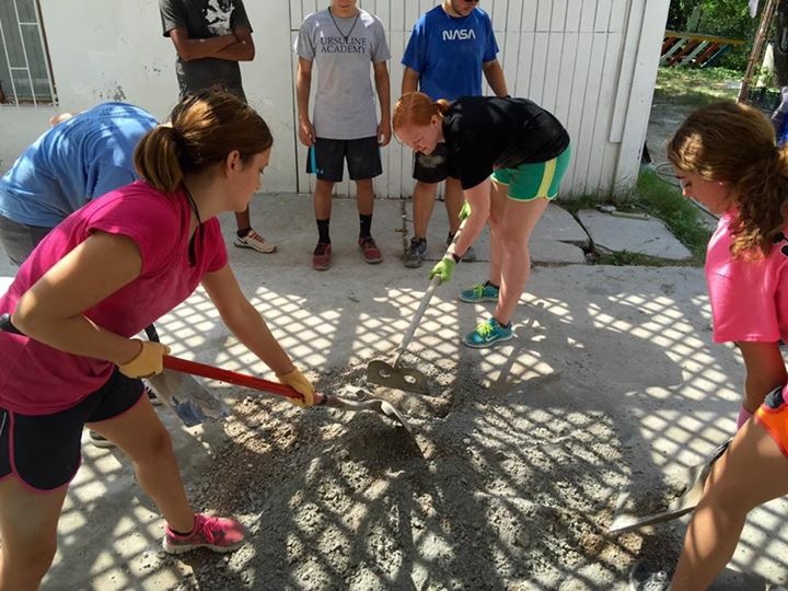 Casa Bethesda volunteers working hard to flatten the foundation for their expansion