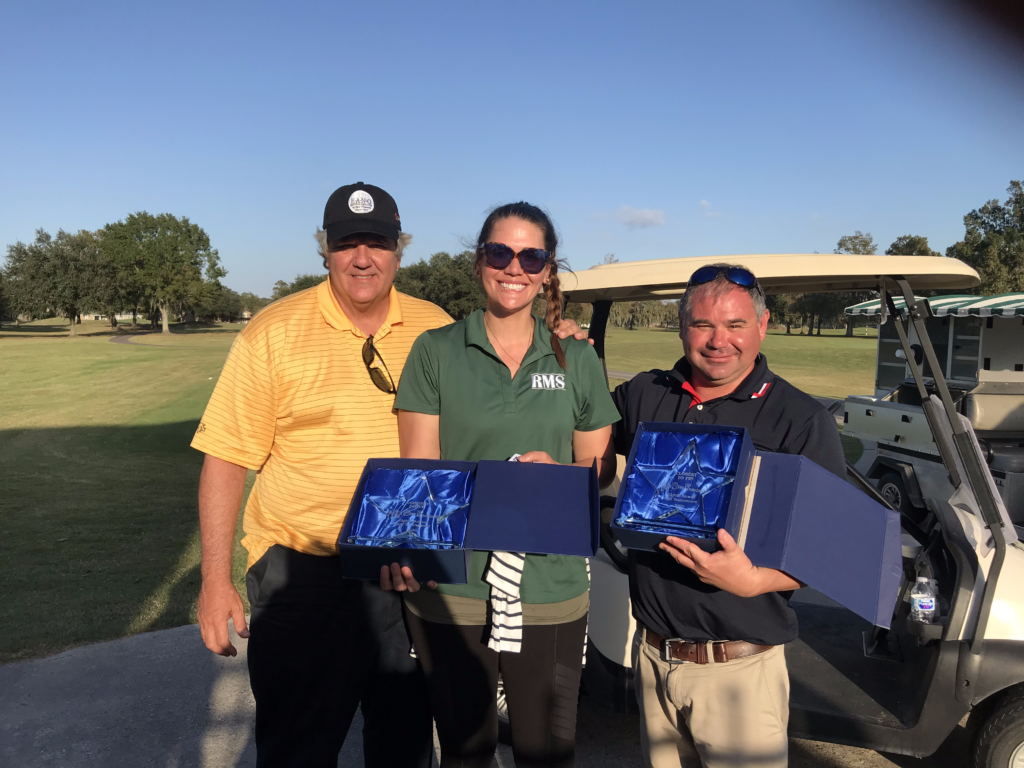 golf classic participants posed with their awards