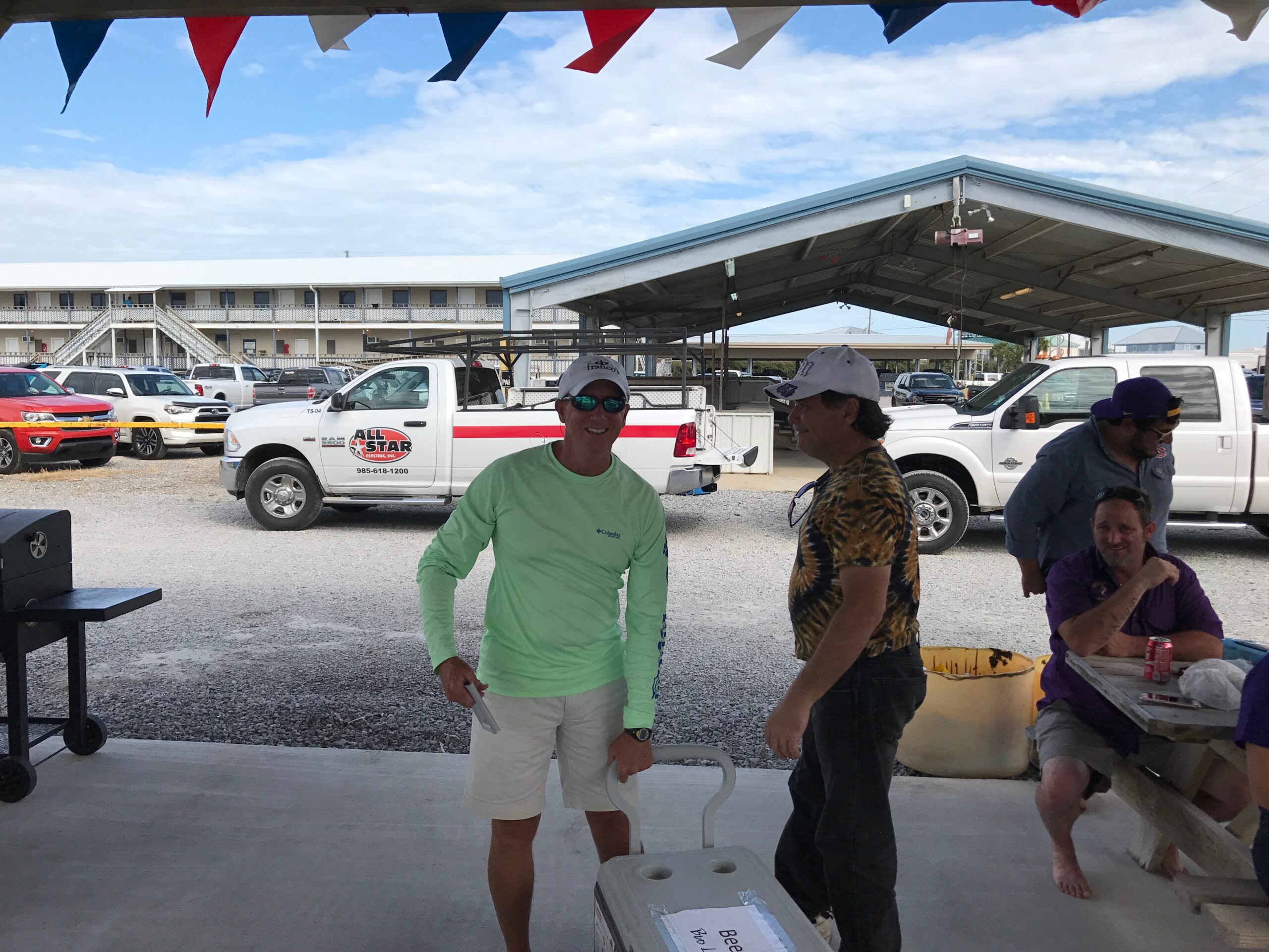 Grand isle slam participants moving an ice chest