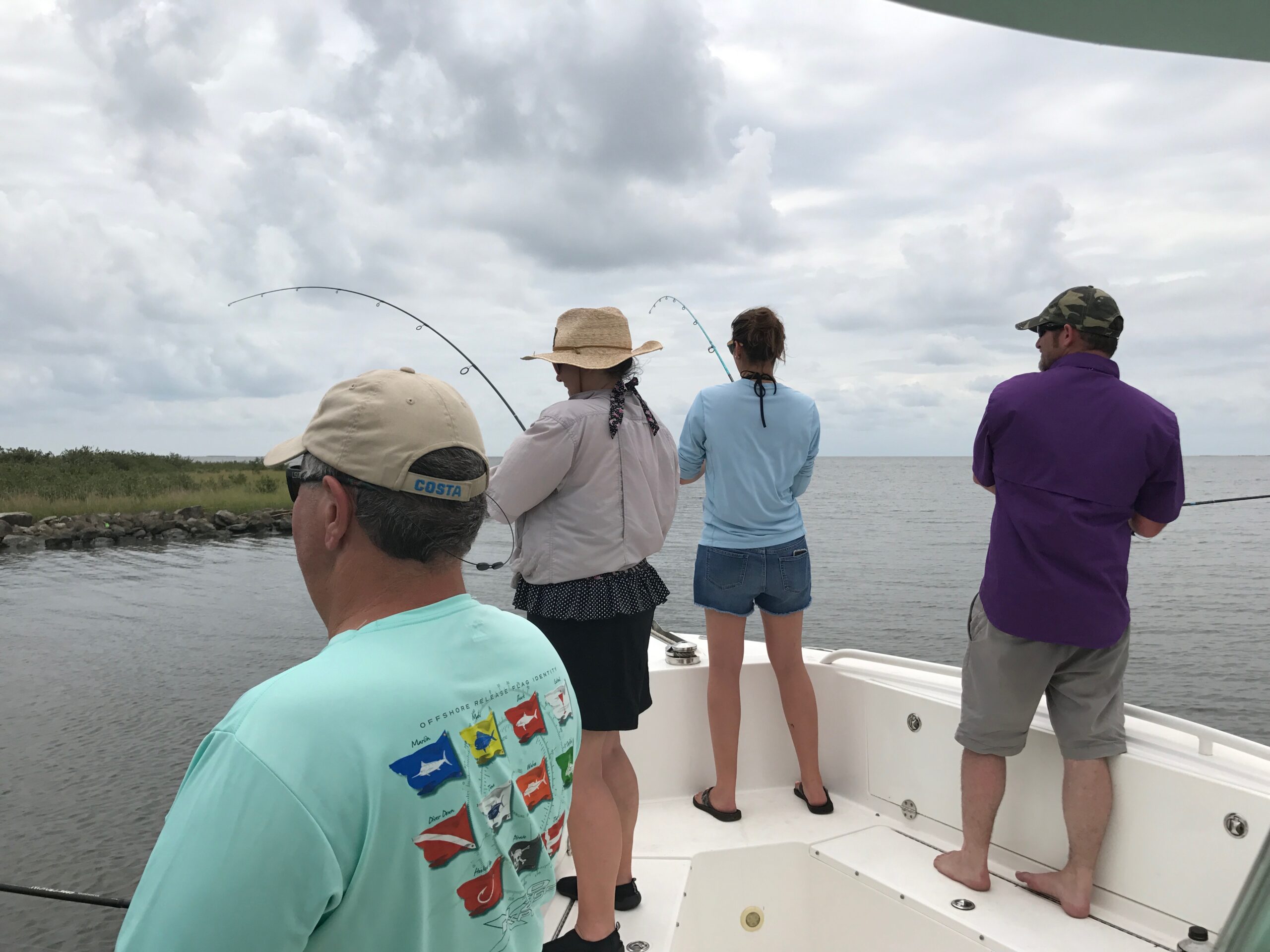 group photo of grand isle slam participants fishing on the coast of an island